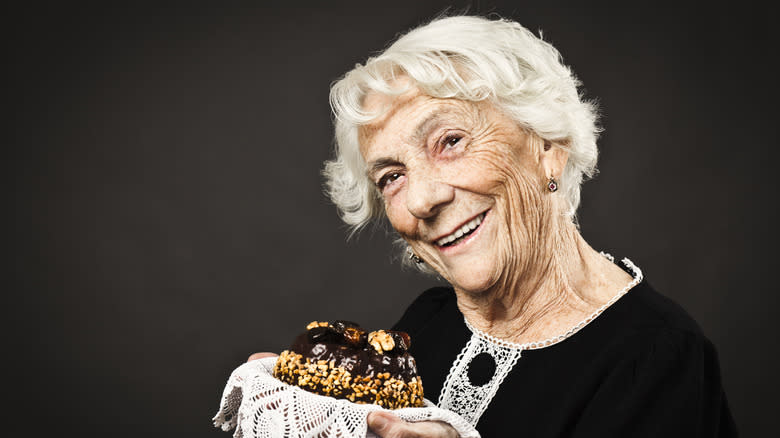 Happy grandma displaying cake