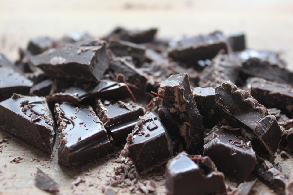 Dark chopped chocolate pieces on wood. 