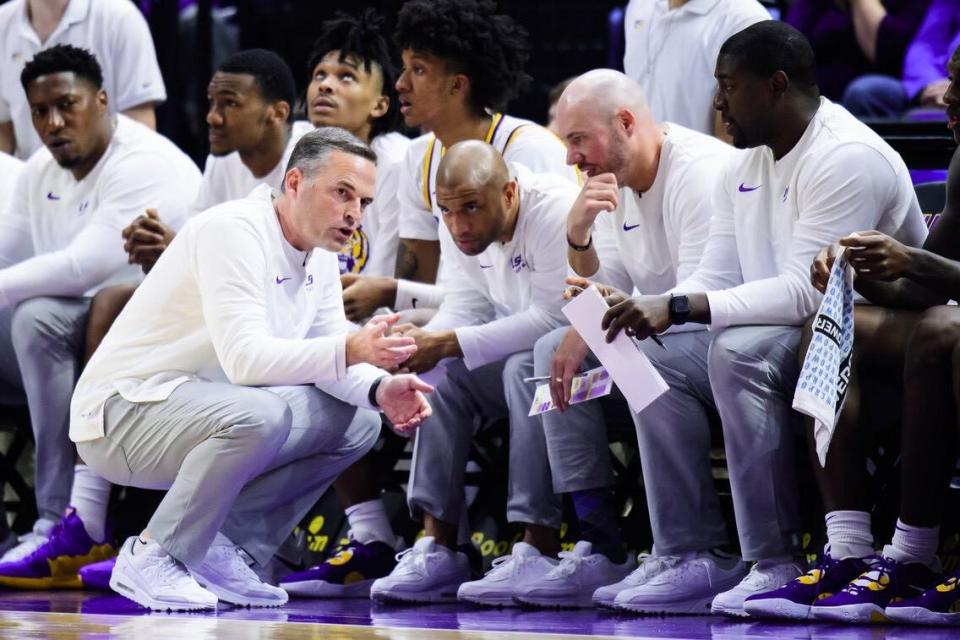 LSU basketball assistant coach Cody Toppert discussing game strategy with head coach Matt McMahon and the rest of the staff.