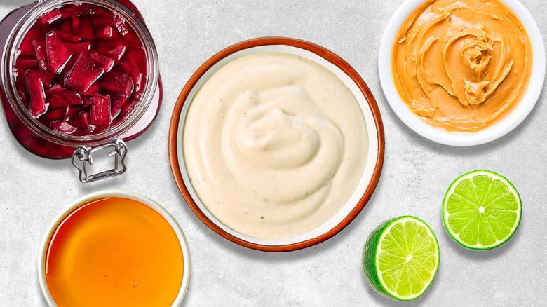 bowl of yogurt, halved lime surrounded by ingredients