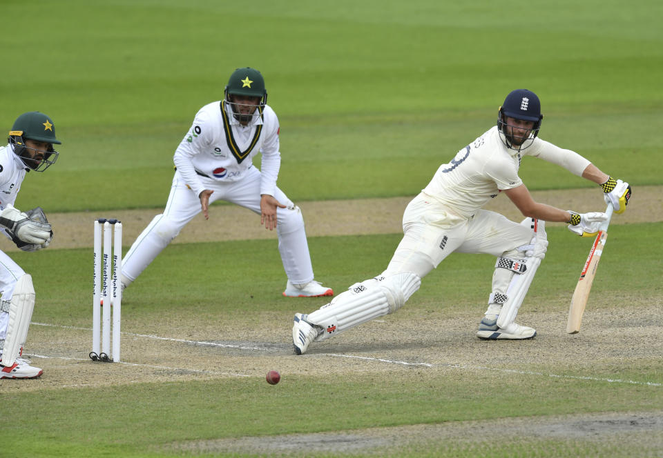 England's Chris Woakes, right, bats during the fourth day of the first cricket Test match between England and Pakistan at Old Trafford in Manchester, England, Saturday, Aug. 8, 2020. (Dan Mullan/Pool via AP)