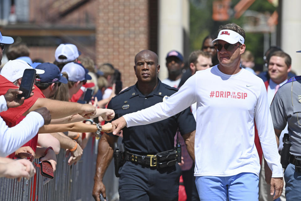 Mississippi head coach Lane Kiffin greets fans during the Walk of Champions before an NCAA college football game against Tulsa in Oxford, Miss., Saturday, Sept. 24, 2022. (AP Photo/Thomas Graning)