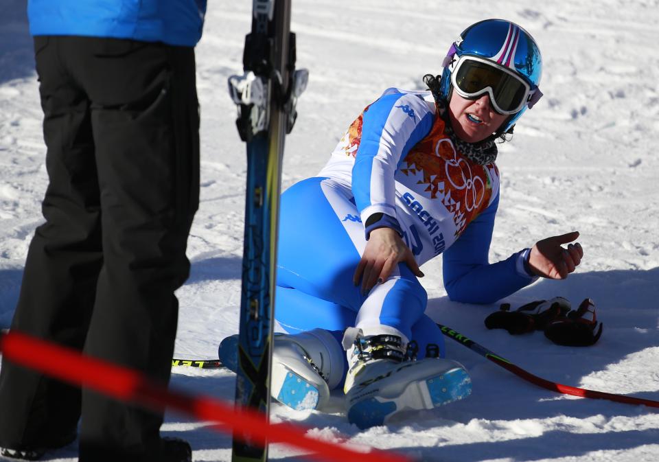 Italy's Daniela Merighetti holds her leg after finishing a women's downhill training run at the Sochi 2014 Winter Olympics, Thursday, Feb. 6, 2014, in Krasnaya Polyana, Russia. (AP Photo/Gero Breloer)