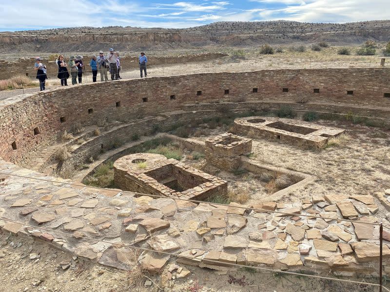 Tourists view Pueblo Bonito, one of a series of Puebloan structures in Chaco Canyon