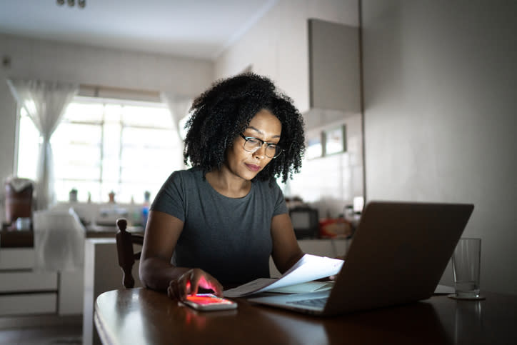 A woman calculates her liabilities