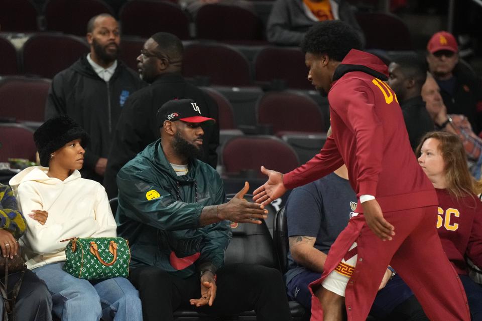 Jan 10, 2024; Los Angeles, California, USA; Southern California Trojans guard Bronny James (6) is greeted by father LeBron James during the game against the Washington State Cougars at Galen Center. Mandatory Credit: Kirby Lee-USA TODAY Sports