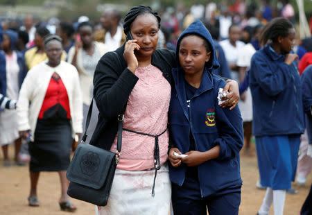 A parent embraces a student following a fire which burnt down one dormitory of Moi Girls school in Nairobi, Kenya September 2, 2017. REUTERS/Baz Ratner