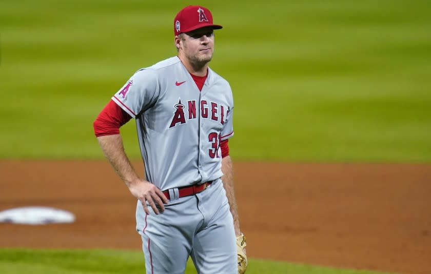 Los Angeles Angels relief pitcher Ty Buttrey reacts after giving up a solo home run to Colorado Rockies' Ryan McMahon.