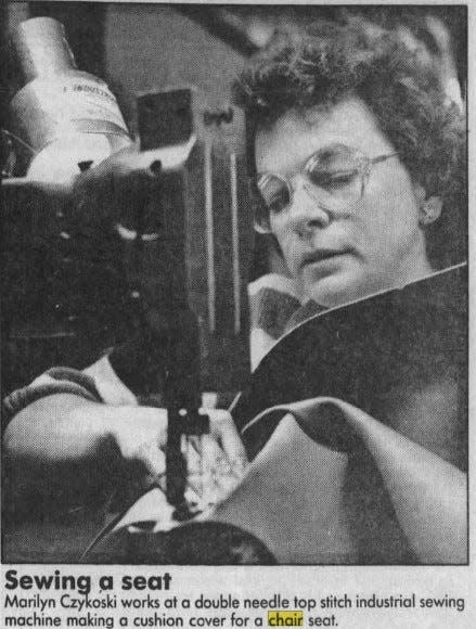 Marilyn Czykoski stitches a chair seat using an industrial sewing machine, as seen in 1990.