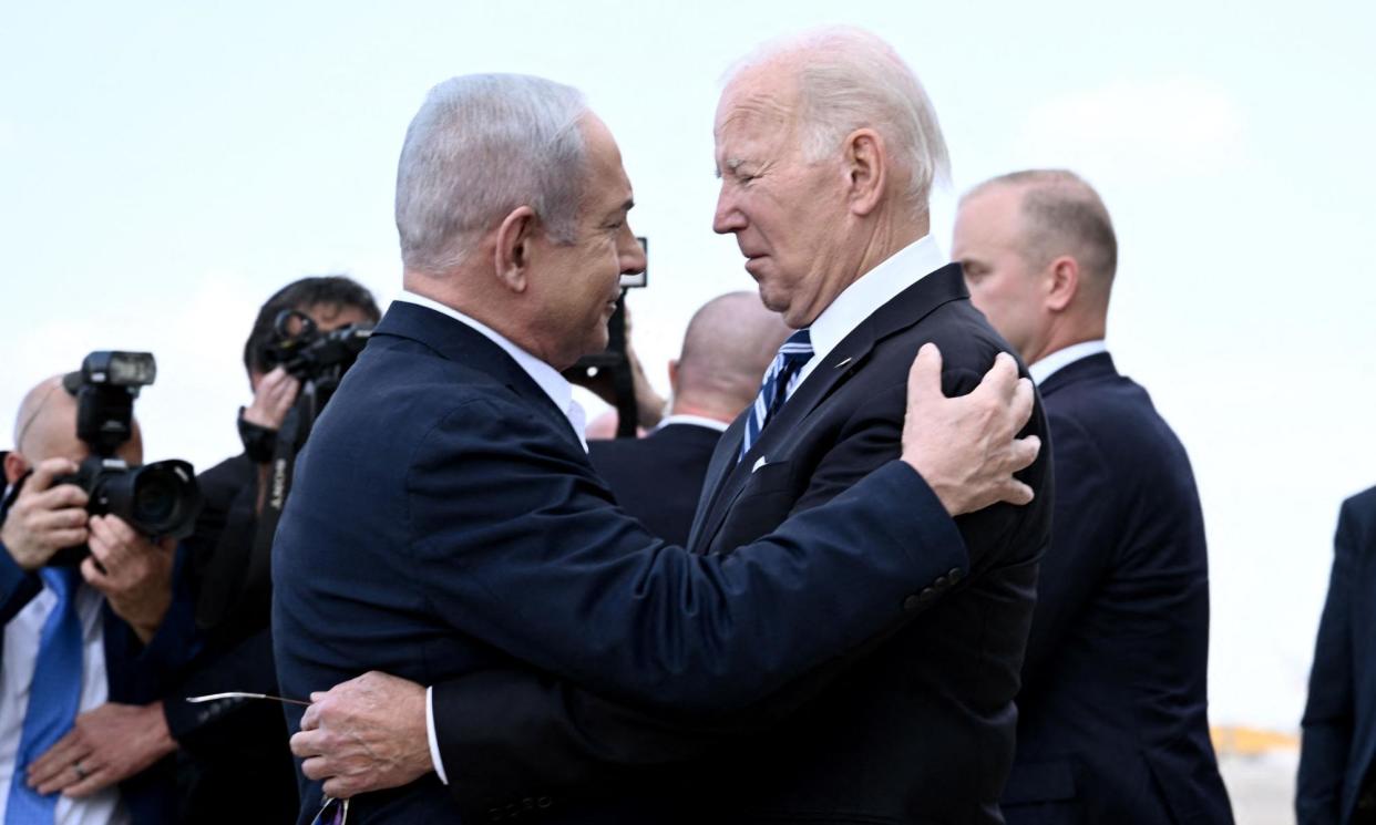 <span>Benjamin Netanyahu greets Joe Biden at Tel Aviv's Ben Gurion airport on 18 October 2023.</span><span>Photograph: Brendan Smialowski/AFP/Getty Images</span>