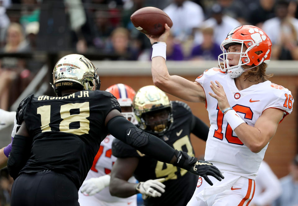 Wake Forest pass rusher Carlos Basham Jr. will have his ears pinned back against Trevor Lawrence, right, on Saturday. (Photo by Streeter Lecka/Getty Images)