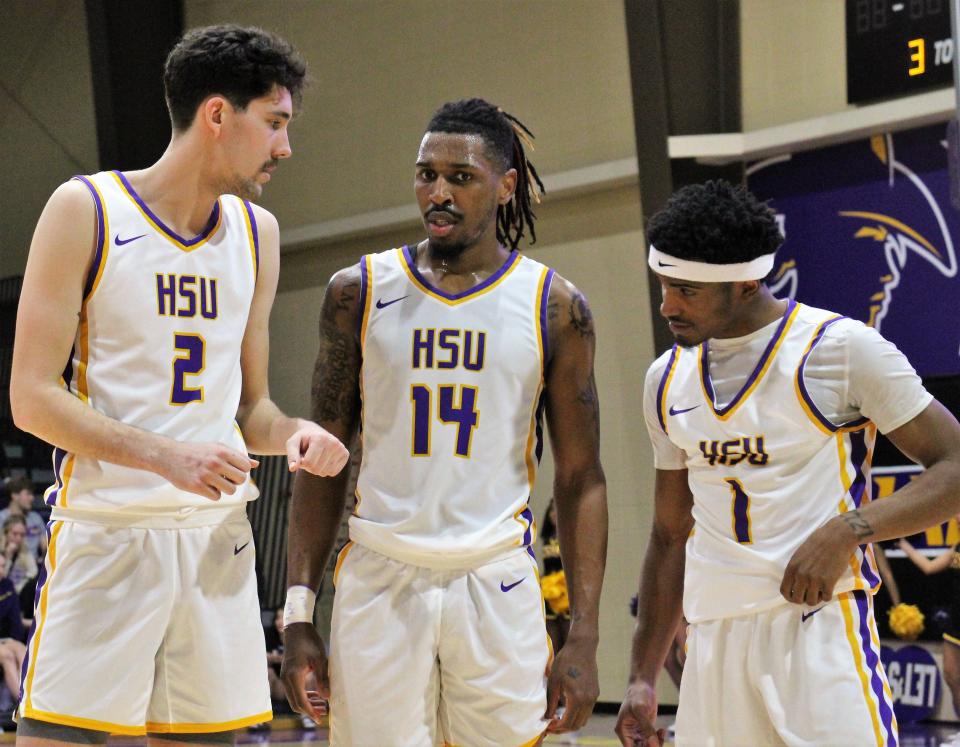 HSU's three double-figure scorers talk it over during a timeout Tuesday against Concordia. Stamford High grad Austin Brewer (2) had 13 points and 14 rebounds, Steven Quinn (14) scored a career-high 39 points and guard Jason Justice (1) had 17 points.