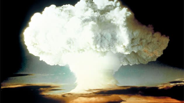 A mushroom cloud rising white, blotting horizon, in OP Ivy, Mike shot atomic bomb test blast. Photo: Getty.