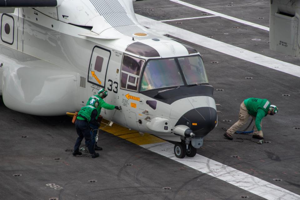 Sailors prepare a CMV-22B Osprey, assigned to the “Titans” of Fleet Logistics Multi-Mission Squadron (VRM) 30, for flight on the flight deck of <em>Nimitz</em>-class aircraft carrier USS <em>Carl Vinson</em> (CVN 70). (U.S. Navy photo by Mass Communication Specialist Seaman Joshua Sapien)