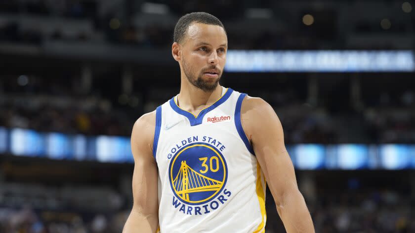 Closeup of a professional basketball player in a jersey that says Golden State Warriors.