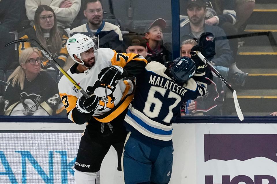 Mar 30, 2024; Columbus, Ohio, USA; Columbus Blue Jackets left wing James Malatesta (67) takes a hit from Pittsburgh Penguins defenseman Pierre-Olivier Joseph (73) during the second period of the NHL hockey game at Nationwide Arena.