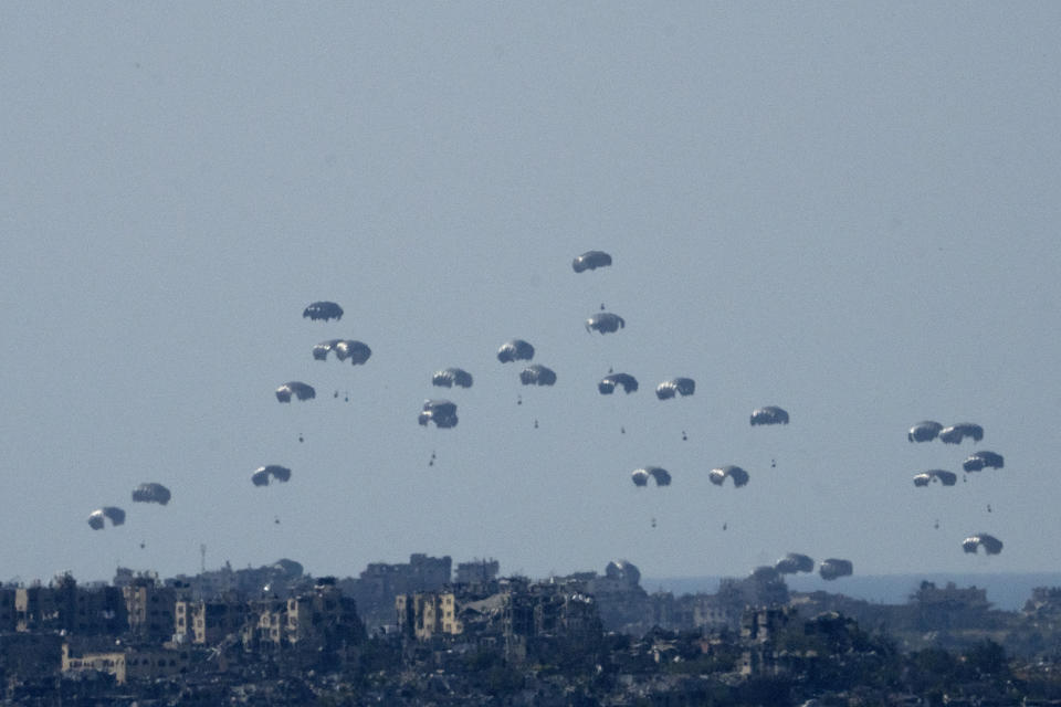 Parachutes drop humanitarian aid into the northern Gaza Strip, as seen from southern Israel, Monday, March 11, 2024. (AP Photo/Maya Alleruzzo)