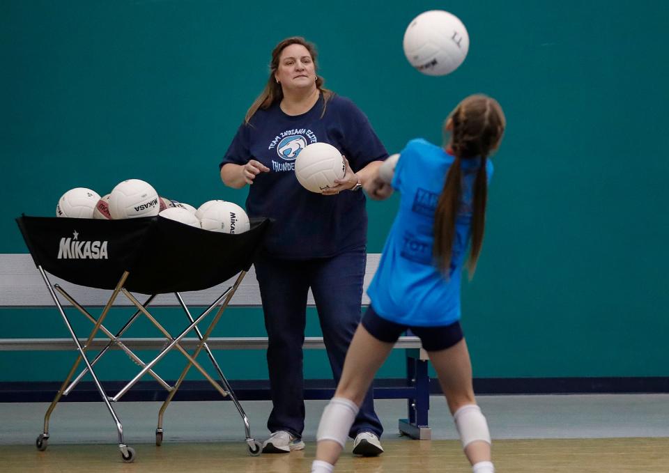 Team Indiana Thundercats head volleyball coach Rebecca Murray leads her team through practice Monday, Feb. 28, 2022, in Indianapolis. Murray is in her 19th season coaching 11- and 12-year-old girls for Team Indiana. 