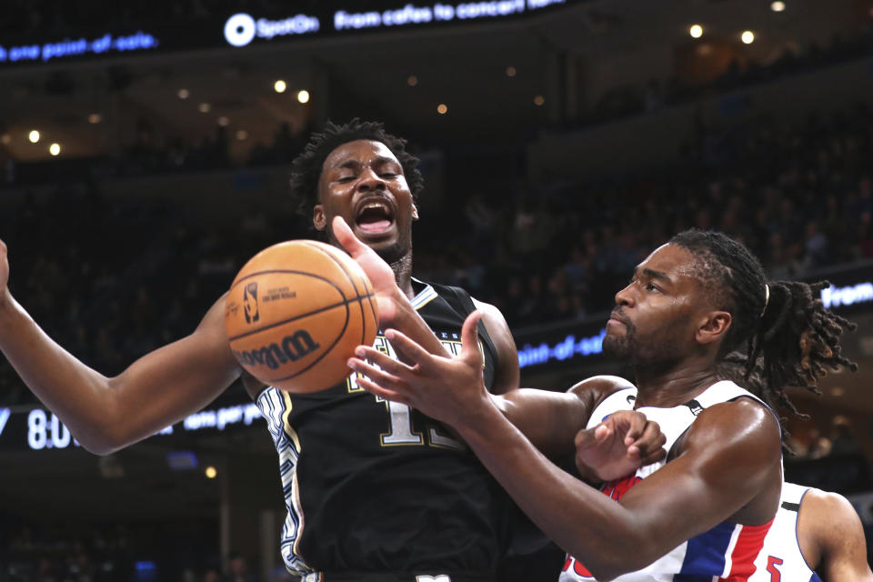 Memphis Grizzlies forward Jaren Jackson Jr. (13) vies for a rebound with Detroit Pistons forward Isaiah Stewart, right, during the first half of an NBA basketball game Friday, Dec. 9, 2022, in Memphis, Tenn. (AP Photo/Nikki Boertman)