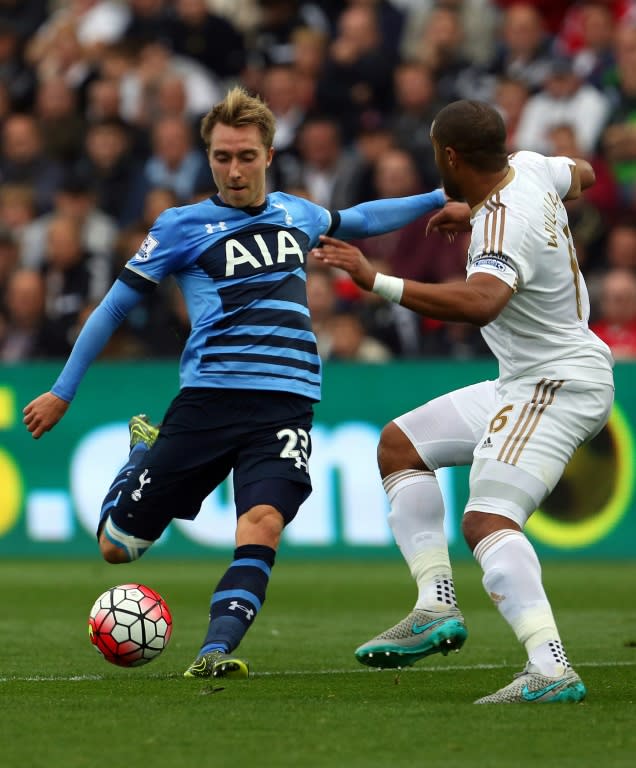 Tottenham Hotspur's midfielder Christian Eriksen (L) attempts a shot on goal during an English Premier League football match against Swansea City at The Liberty Stadium in Swansea, south Wales on October 4, 2015