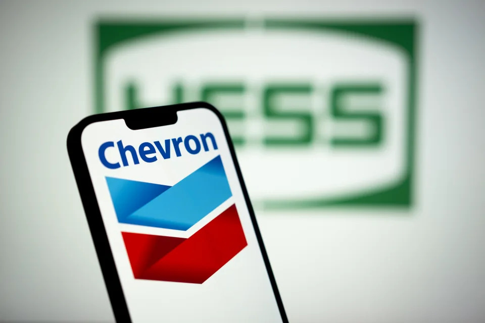 The Chevron logo is seen with the Hess logo in the background in this photo illustration on 13 March, 2023 in Warsaw, Poland. (Photo by Jaap Arriens/NurPhoto via Getty Images)