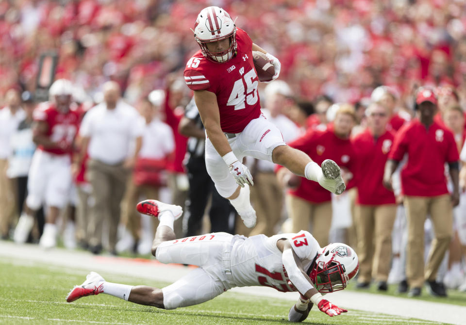 Sep 8, 2018; Madison, WI, USA; Wisconsin Badgers fullback Alec Ingold (45) leaps over New Mexico Lobos cornerback Jalin Burrell (13) during the second quarter at Camp Randall Stadium. Mandatory Credit: Jeff Hanisch-USA TODAY Sports