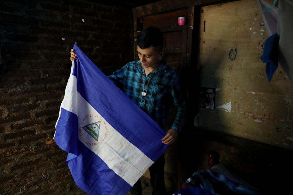 Erlinton Flores Ortiz with a Nicaraguan flag. "Nicaraguans deserve to know the truth," he says.