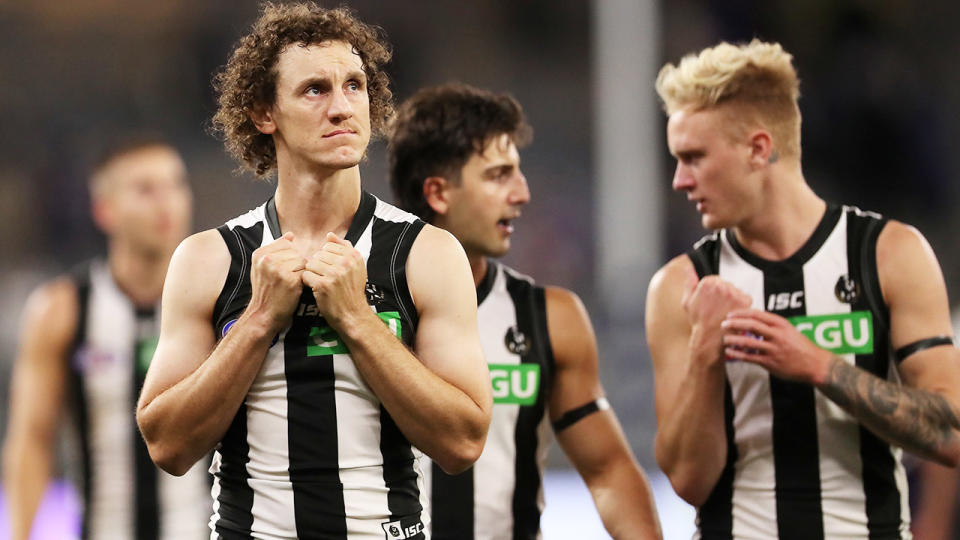 Collingwood players, pictured here looking dejected after their loss to Fremantle in the AFL.