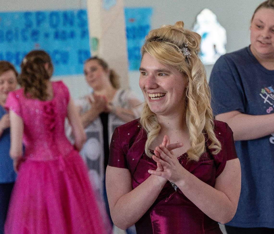 Centennial High School student Katie Baugh applauds as students arrive for VIP Prom on Saturday at Potomac Manor Event Center.