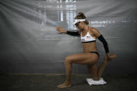 April Ross, of the United States, stretches before entering the court prior to a women's beach volleyball match against Germany at the 2020 Summer Olympics, Tuesday, Aug. 3, 2021, in Tokyo, Japan. (AP Photo/Felipe Dana)