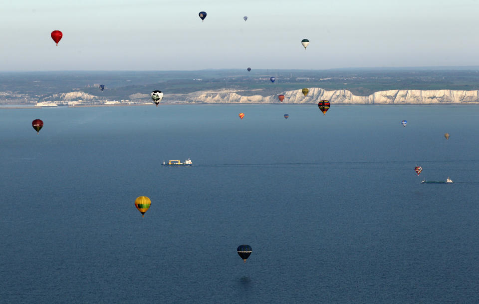 IN FLIGHT, UNITED KINGDOM - APRIL 07: Hot air balloons which departed from Lydden Hill race circuit near Canterbury take part in a mass crossing of the English Channel on April 7, 2011 near Dover, England. 51 balloonists of various nationalities from across Europe took off from Kent making for Calais, France at about 7am. It is the first time a Guinness World Record bid has been made for "the largest group of hot air balloons to make the Channel crossing". (Photo by Oli Scarff/Getty Images)