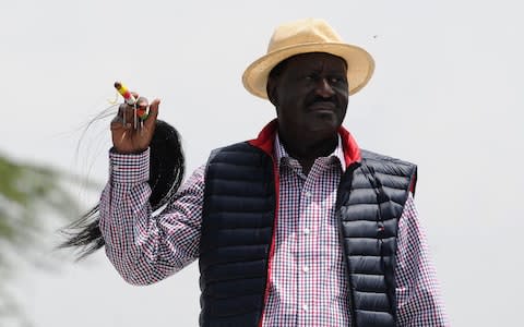 Kenyan's opposition party National Super Alliance (NASA) leader Raila Odinga looks on during a demonstration following his arrival to the Jomo Kenyatta International airport on November 17 - Credit:  AFP