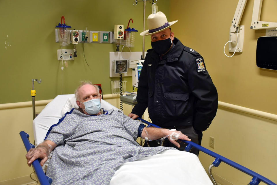 CORRECTS CITY TO OWEGO, N.Y. This photo, provided by the New York State Police, shows Kevin Kresen, 58, of Candor, NY, and New York State Police Sgt, Jason Cawley, in Lourdes Hospital, in Binghamton, NY. Cawley rescued Kresen from his car, in Owego, NY, where he was stranded for 10 hours, covered by nearly 4 feet of snow thrown by a plow during this week's storm. (New York State Police via AP)