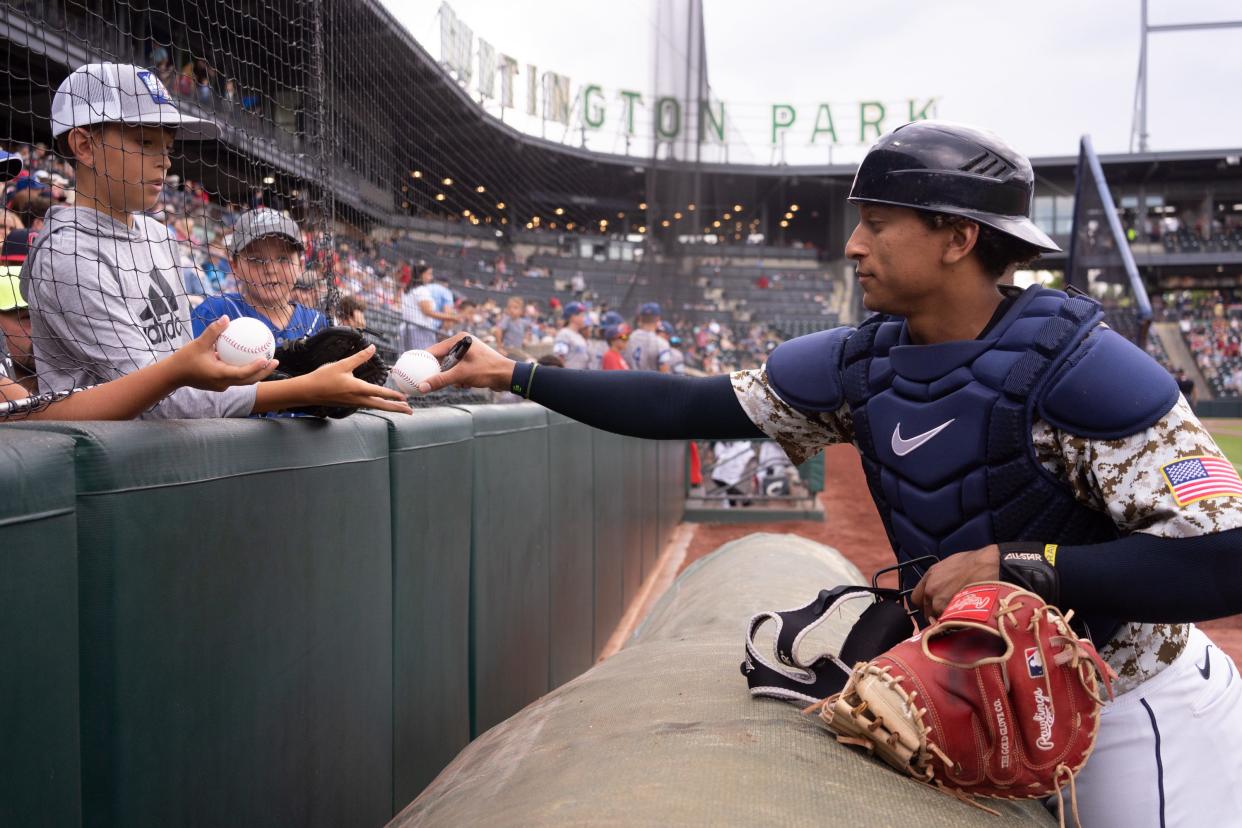 Columbus Clippers catcher Bo Naylor (12) signs baseballs for fans before a Triple-A Minor League baseball game against the Indianapolis Indians, Wednesday, July 13, 2022, at Huntington Park in Columbus, Ohio. Jul 13, 2022; Columbus, Ohio, United States;  Mandatory Credit: Joe Timmerman-The Columbus Dispatch