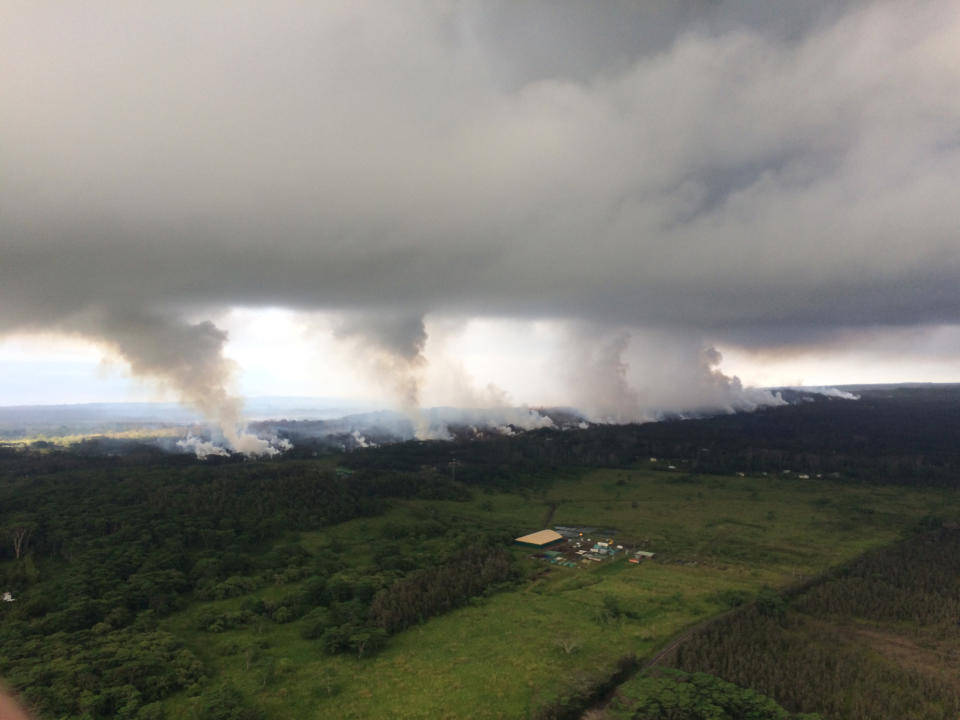 <p>This Wednesday, May 16, 2018, image provided by the U.S. Geological Survey shows sulfur dioxide plumes rising from fissures along the rift and accumulating in the cloud deck, viewed from the Hawaiian Volcano Observatory overflight in the morning at 8:25 a.m., HST near Pahoa, Hawaii. Plumes range from 1 to 2 kilometers (3,000 to 6,000 feet) above the ground. Officials say some vents formed by Kilauea volcano are releasing such high levels of sulfur dioxide that the gas poses an immediate danger to anyone nearby. (Photo: U.S. Geological Survey via AP) </p>