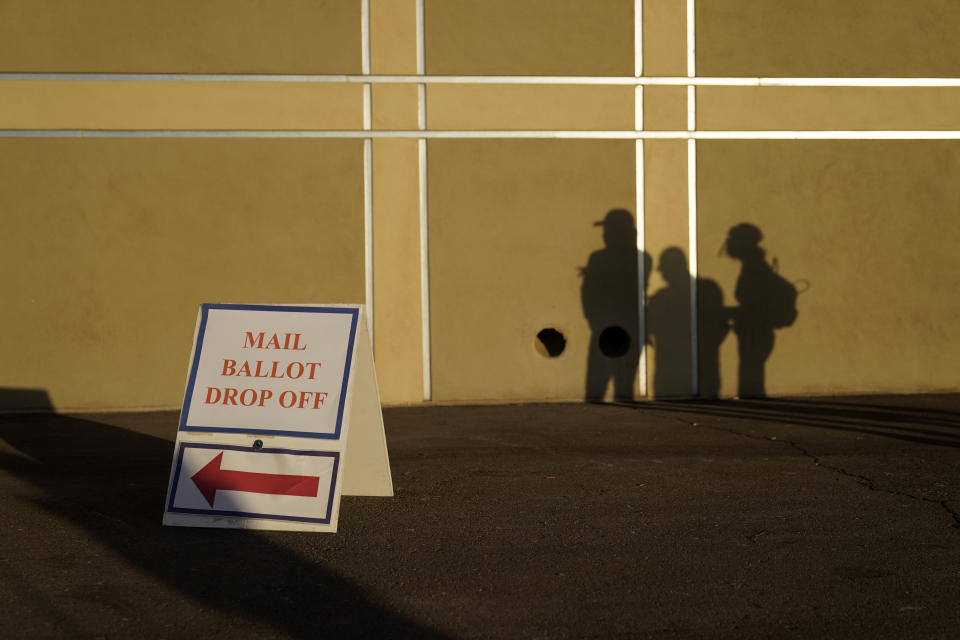 People wait outside of a polling place on Election Day, Tuesday, Nov. 3, 2020, in Las Vegas. (AP Photo/John Locher)