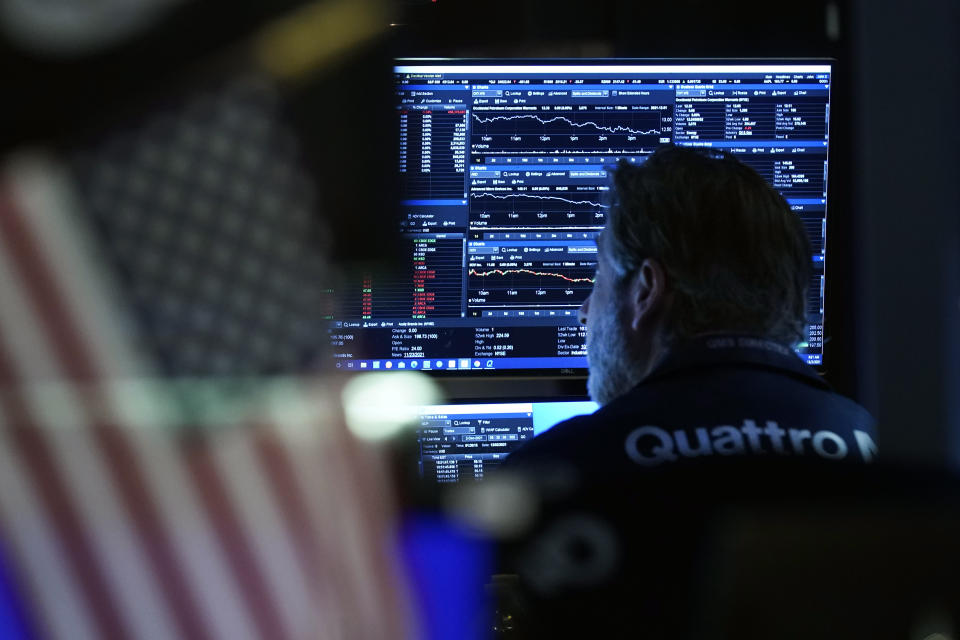 Trader John Romolo works on the floor of the New York Stock Exchange, Thursday, Dec. 2, 2021. Stocks are opening mostly higher on Wall Street Thursday as investors continue to monitor the spread of the new coronavirus variant as well as measures that the U.S. and other governments are taking to restrain it. (AP Photo/Richard Drew)