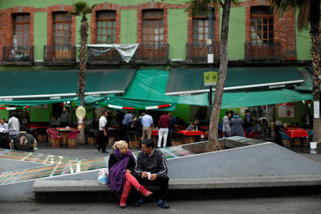 People chat near a crime scene hours after unknown assailants attacked people with rifles and pistols at an intersection on the edge of the tourist Plaza Garibaldi in Mexico City, Mexico September 15, 2018. REUTERS/Gustavo Graf