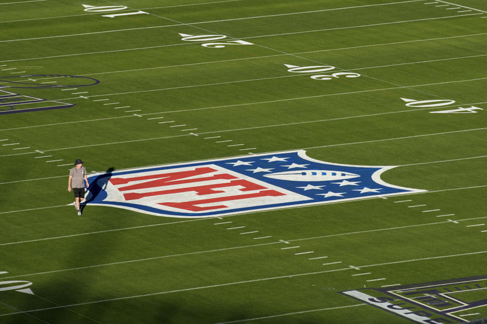 A person walks on the Allegiant Stadium football field ahead of the Super Bowl, Tuesday, Jan. 30, 2024, in Las Vegas. (AP Photo/John Locher)