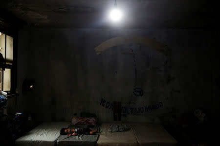 A child, relative of a member of the roofless movement who lives together with members of lesbian, gay, bisexual and transgender (LGBT) community, that have been invited to live in a building that the movement has occupied, sleeps, in downtown Sao Paulo, Brazil, November 28, 2016. REUTERS/Nacho Doce