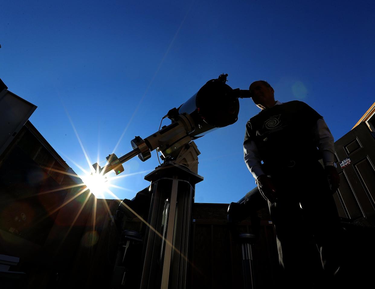 John Shulan, president of the Summit County Astronomy Club looks through a telescope at the observation site at the Bath Nature Preserve on Friday, Sept. 1, 2023, in Bath Township, Ohio.