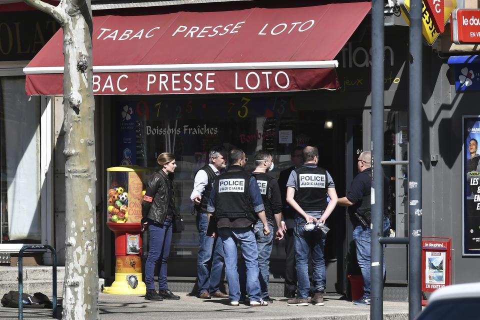 Police officers gather after a man wielding a knife attacked residents venturing out to shop in the town under lockdown, Saturday April 4, 2020 in Romans-sur-Isere, southern France. The alleged attacker was arrested by police nearby, shortly after the attack. Prosecutors did not identify him. They said he had no documents but claimed to be Sudanese and to have been born in 1987. (AP Photo)