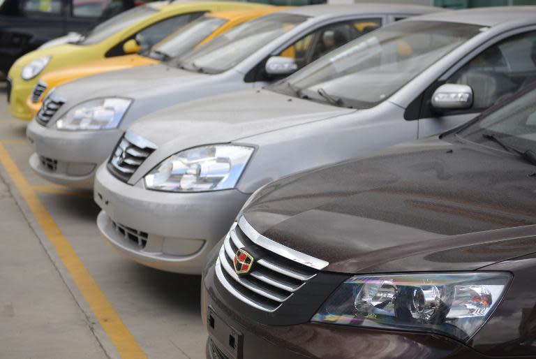 New cars are seen parked at a Geely Auto dealership in Shanghai, on August 22, 2013