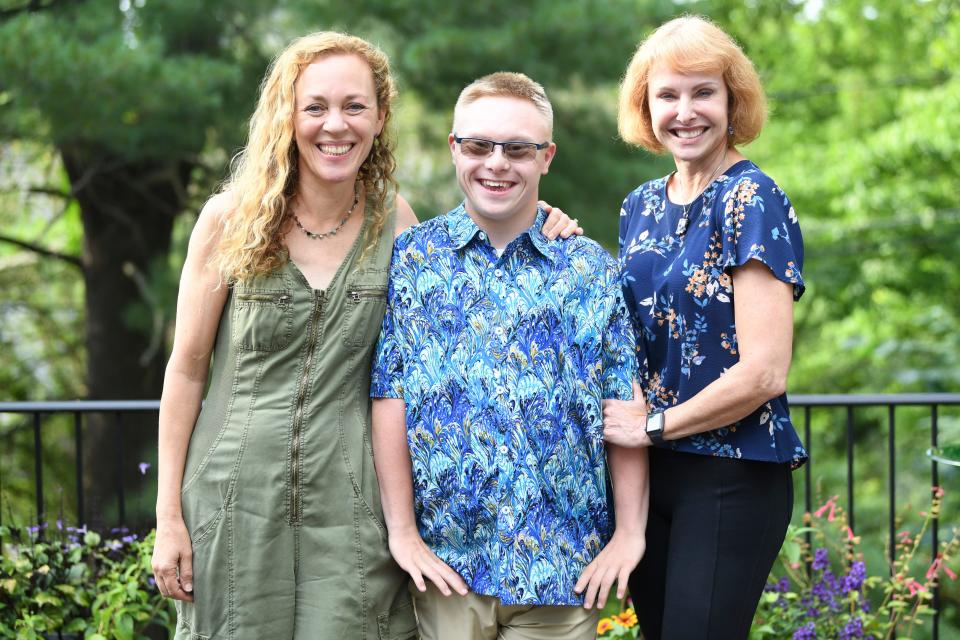 Luka Hyde stands with education advocate Kim Kredich to his left, and his mom and advocate Deborah to his right. The moms have become experts in navigating special education systems and work with others who are fighting on behalf of their children.