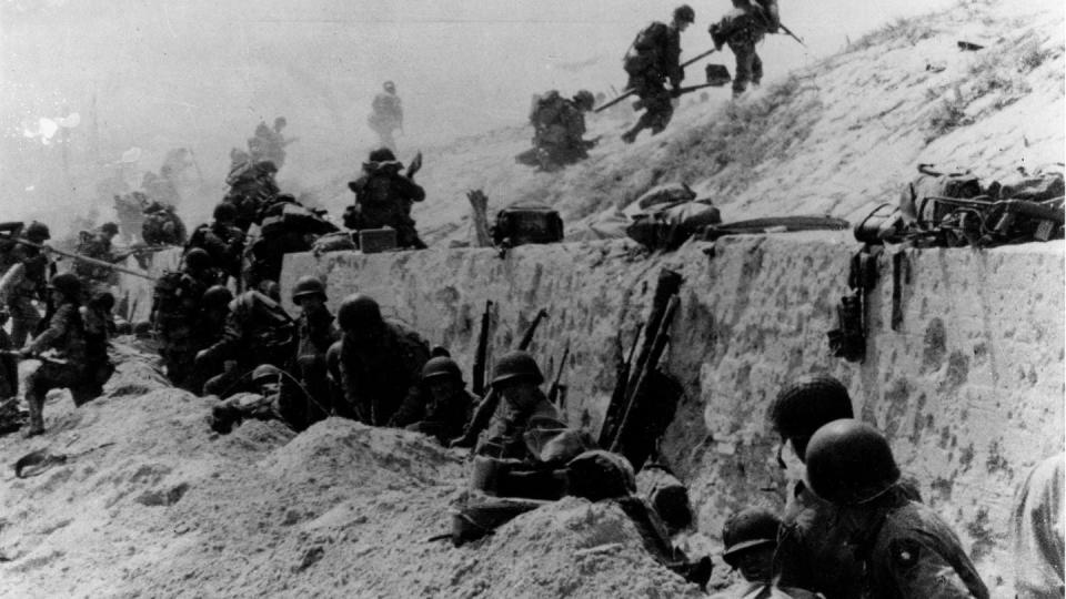 U.S. soldiers of the 4th Infantry Division move out over the seawall on Utah Beach. (Naval History and Heritage Command)