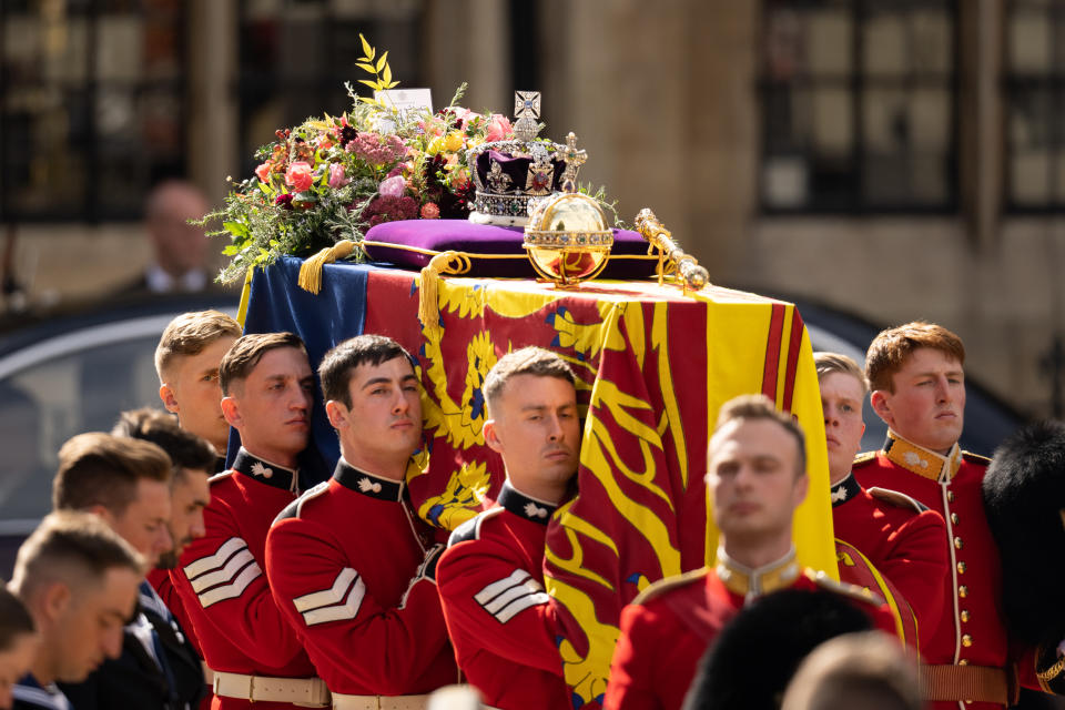 LONDON, ENGLAND - SEPTEMBER 19: The coffin of Queen Elizabeth II with the Imperial State Crown resting on top is carried by the Bearer Party as it departs Westminster Abbey during the State Funeral of Queen Elizabeth II on September 19, 2022 in London, England. Elizabeth Alexandra Mary Windsor was born in Bruton Street, Mayfair, London on 21 April 1926. She married Prince Philip in 1947 and ascended the throne of the United Kingdom and Commonwealth on 6 February 1952 after the death of her Father, King George VI. Queen Elizabeth II died at Balmoral Castle in Scotland on September 8, 2022, and is succeeded by her eldest son, King Charles III. (Photo by Christopher Furlong/Getty Images)