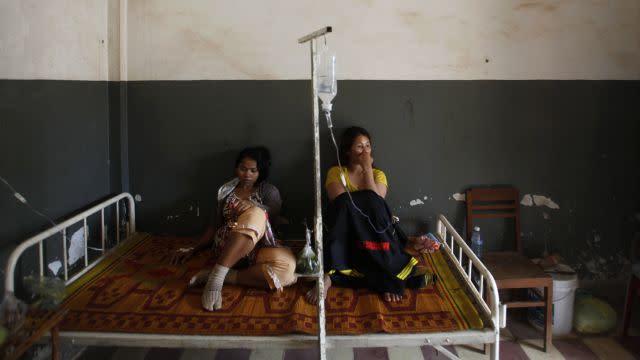 Garment workers from the Six Plus Industry Co. Ltd factory recover at a hospital after fainting at their workplace in Kandal province July 31, 2014. Around 200 workers from the factory producing clothing for Adidas collapsed at work on Thursday morning, said the Free Trade Union (FTU). Another 150 workers fainted on July 26 at the same factory, according to the union. REUTERS/Samrang Pring