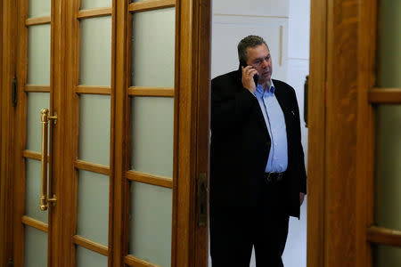 Greek Defence Minister Panos Kammenos talks on his mobile phone as he arrives for a cabinet meeting at the parliament in Athens, Greece April 3, 2018. REUTERS/Costas Baltas/Files