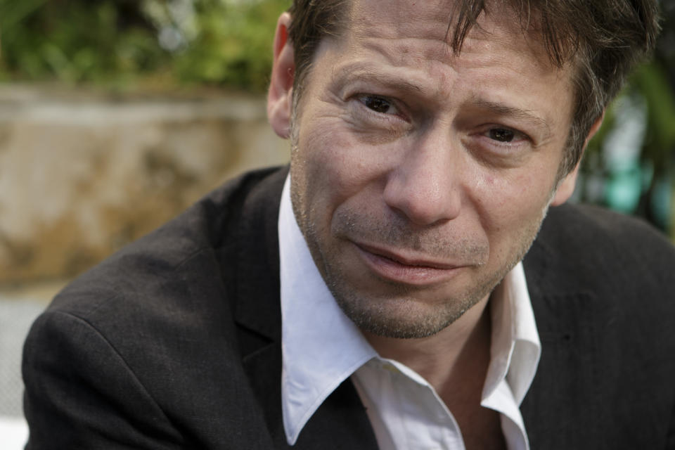 In this photo taken Sunday, May 19, 2013, actor Mathieu Amalric poses for photographs following an interview with The Associated Press at the 66th international film festival, in Cannes, southern France. Amalric depicts a maverick academic counseling Benicio Del Toro's Native American war vet in "Jimmy P.: Psychotherapy of a Plains Indian," director Arnaud Desplechin's Cannes Film Festival contender. (AP Photo/David Azia)