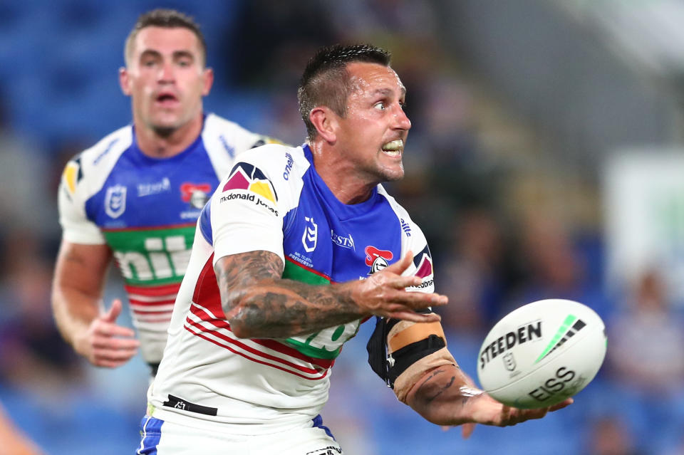 Pictured here, Mitchell Pearce passes the ball for Newcastle in a round 23 match in 2021.